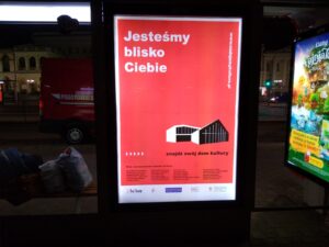 Przystanek autobusowy z dużym plakatem kampanii Nadajemy Kulturę